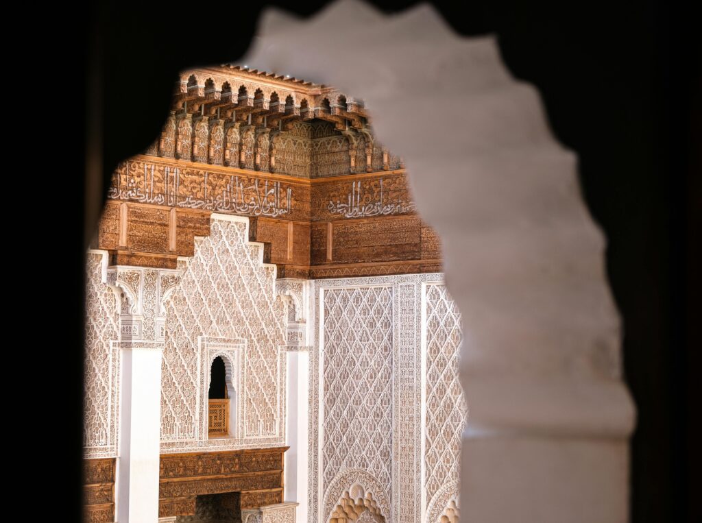 Intricate architectural detail at Ben Youssef Madrasa, Marrakesh, showcasing traditional Moroccan design.