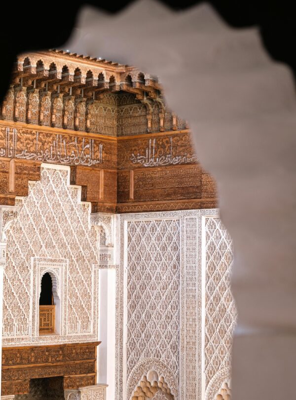Intricate architectural detail at Ben Youssef Madrasa, Marrakesh, showcasing traditional Moroccan design.